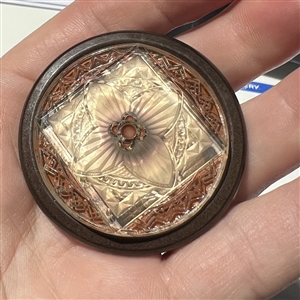 Bohemian pressed glass reverse painted with background reflection showing through.