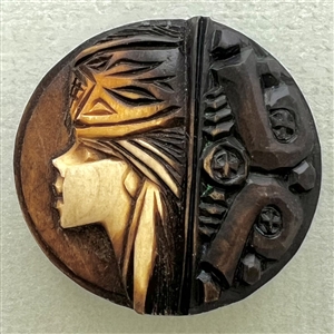 Wood button of a person's head in a hat.