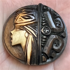 Wood button of a person's head in a hat.