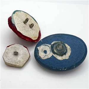 Three Vintage assorted painted plaster buttons.