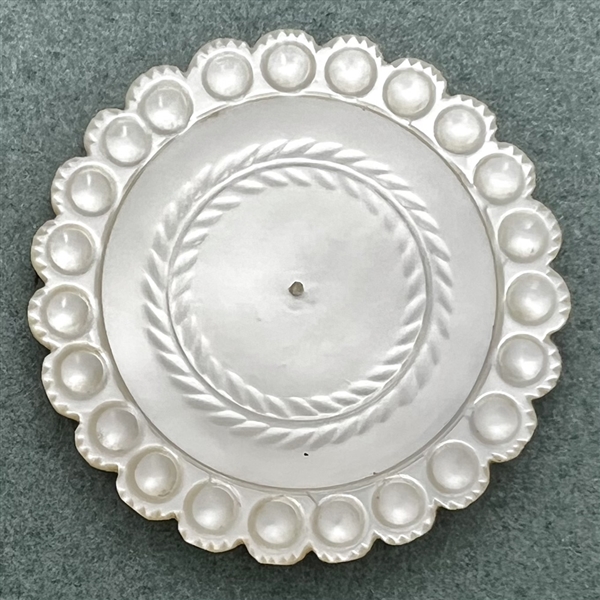 An 18th c. pearl with scalloped edge.