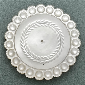 An 18th c. pearl with scalloped edge.