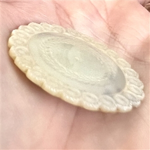 An 18th c. pearl with scalloped edge.