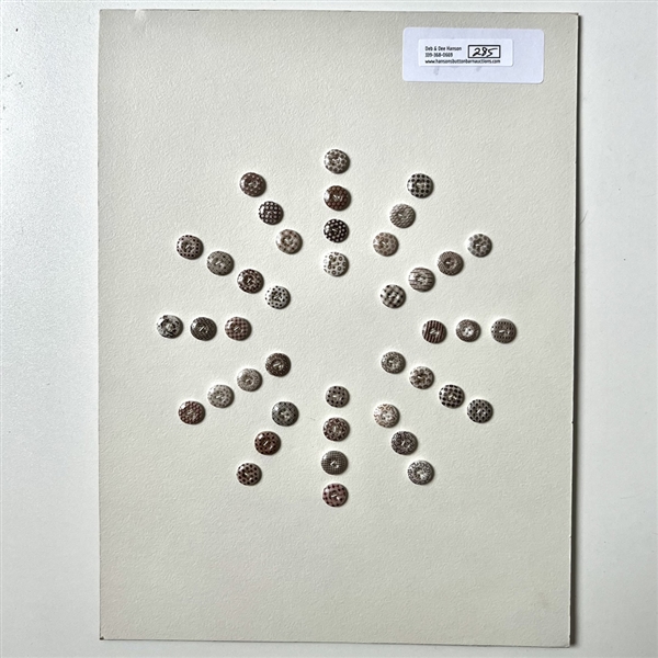 Card of forty two small china calico buttons in brown. 