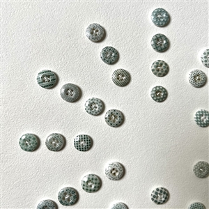 Card of forty two small china calico buttons in green. 