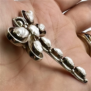 Silver button of a realistic dragonfly with seed pearls.