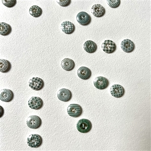 Card of forty two small china calico buttons in green. 