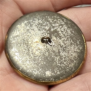 Animal fur with brass rim and tin back button.