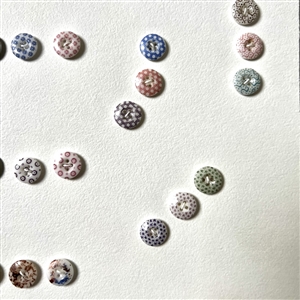 Card of forty two small china calico buttons.