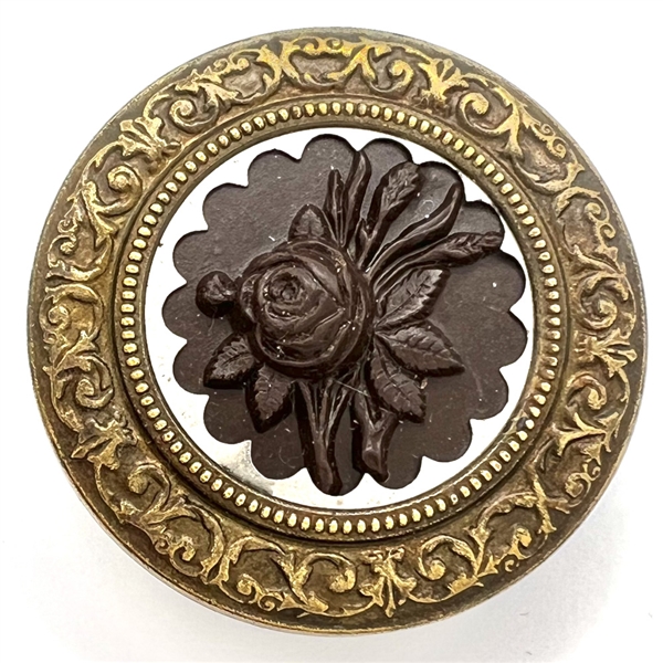 A 19th c. Button with gutta percha rose in steel collet and a detailed brass border.