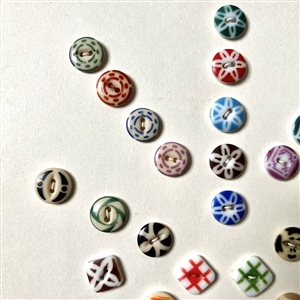 Card of forty two small - medium china stencil buttons.