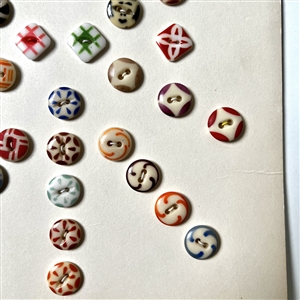 Card of forty two small - medium china stencil buttons.