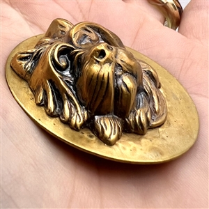 Brass button of a terrier.