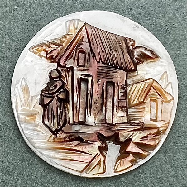 A 19th c. Carved pearl button of a woman and buildings. 