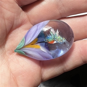 Mary Gaumond's hummingbird drinking from flower glass studio button.