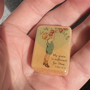 Nancy Dubois studio button of child picking apples. 