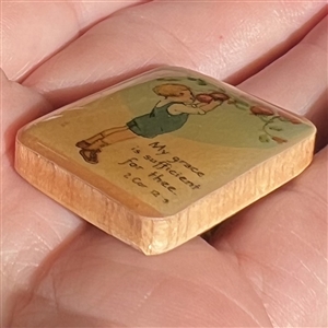 Nancy Dubois studio button of child picking apples. 