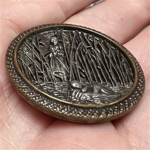 Metal button (pewter?) of “Moses in the bulrushes story from the Book of Exodus. 