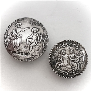 Two silver buttons of people in nature.