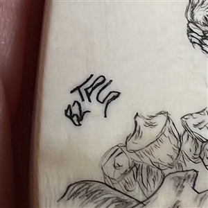 Scrimshaw natural material button of a squirrel eating.