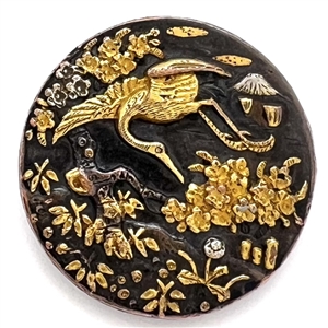 Shakudo button of a crane flying with flowers.