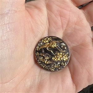 Shakudo button of a crane flying with flowers.