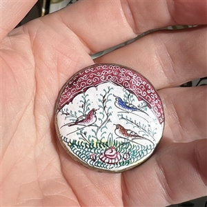 Enamel button of birds in a garden set in silver (?). 