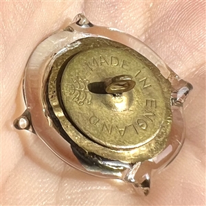 Bimini clear glass button with gold luster of an urn. 