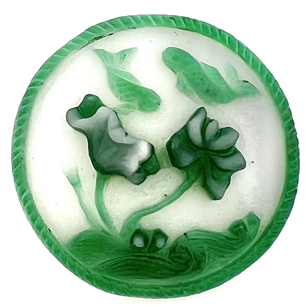 Peking glass button of two koi swimming with water plants.