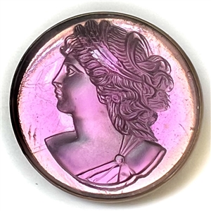 Amethyst glass in metal button of a womans head in profile.