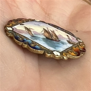 A 19th c. Enamel button of ships in a harbor.