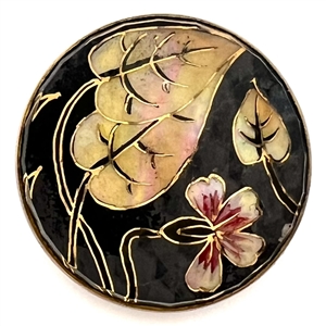 Flower and leaves reverse painted on faceted glass over iridescent celluloid set in metal button.