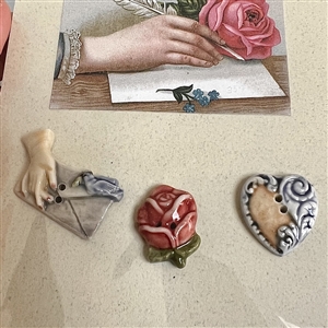 Original store card with three hand-painted porcelain buttons.