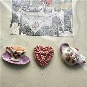 Original store card with three hand-painted porcelain buttons.