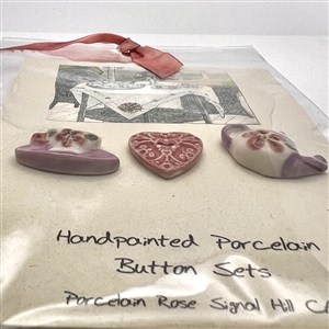 Original store card with three hand-painted porcelain buttons.