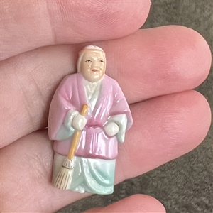 Japanese Arita porcelain button of a realistic figure with a broom.