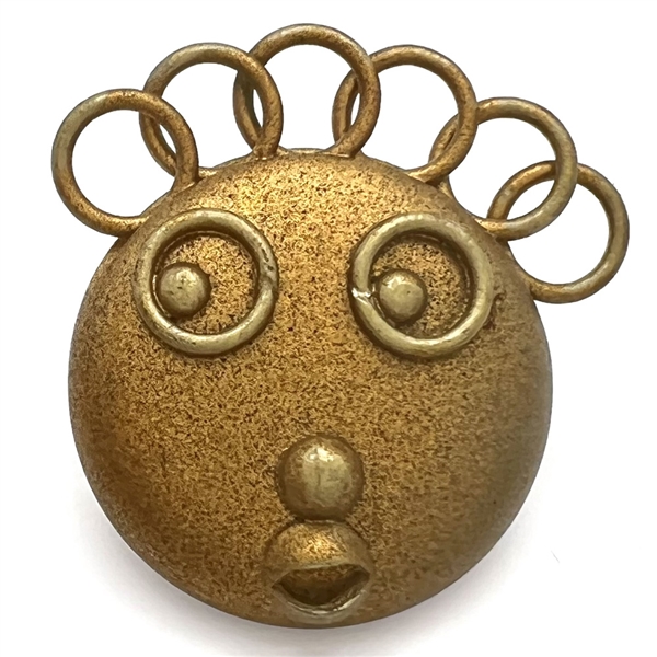 Painted celluloid goofie button of a funny face and crazy hair.
