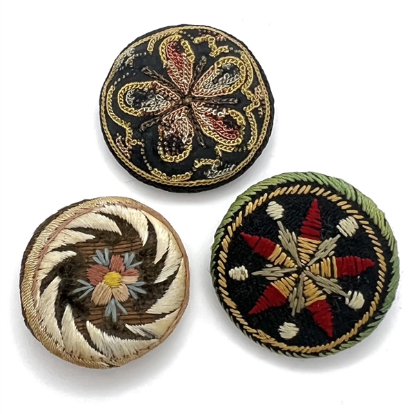 Three 19th c. Fabric buttons of flowers and patterns.