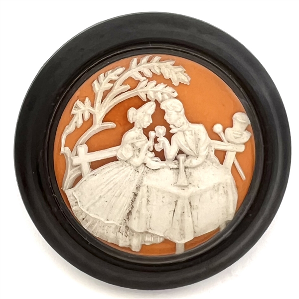 Vintage British plastic button of man and woman dining.