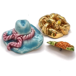 Three couture buttons by French ceramist Helene Mechin.