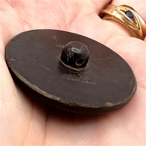 Vintage British plastic button of man and woman dining.