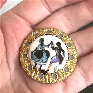 Painted porcelain set in metal button of man and woman dancing. 