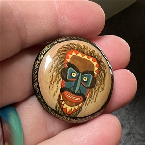 Russian lacquer button of a Lacota (Native American) mask. 