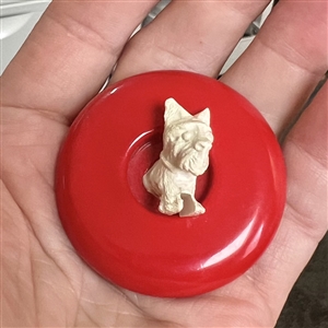 Vintage celluloid button of scotty dog jumping out of center of button.
