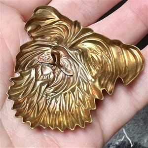 Stamped brass studio button of “Trixie by Kevin Kinne.