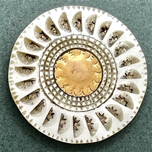 An 18th c. pearl button with carved slits and gold center.