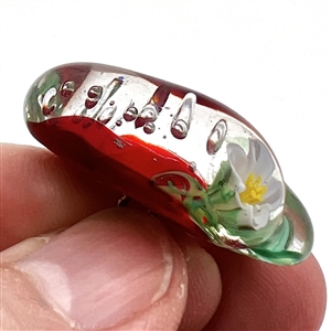 Mary Gaumond's torch-worked glass studio button of a realistic strawberry.