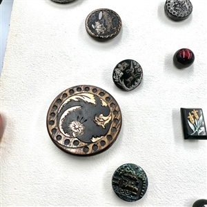 Card of 25 black glass buttons. 