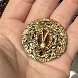 A 19th c. Brass button with an enamel background.