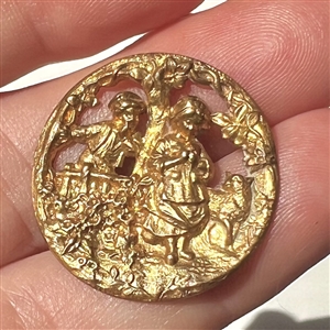 A 19th c. brass button of two children.